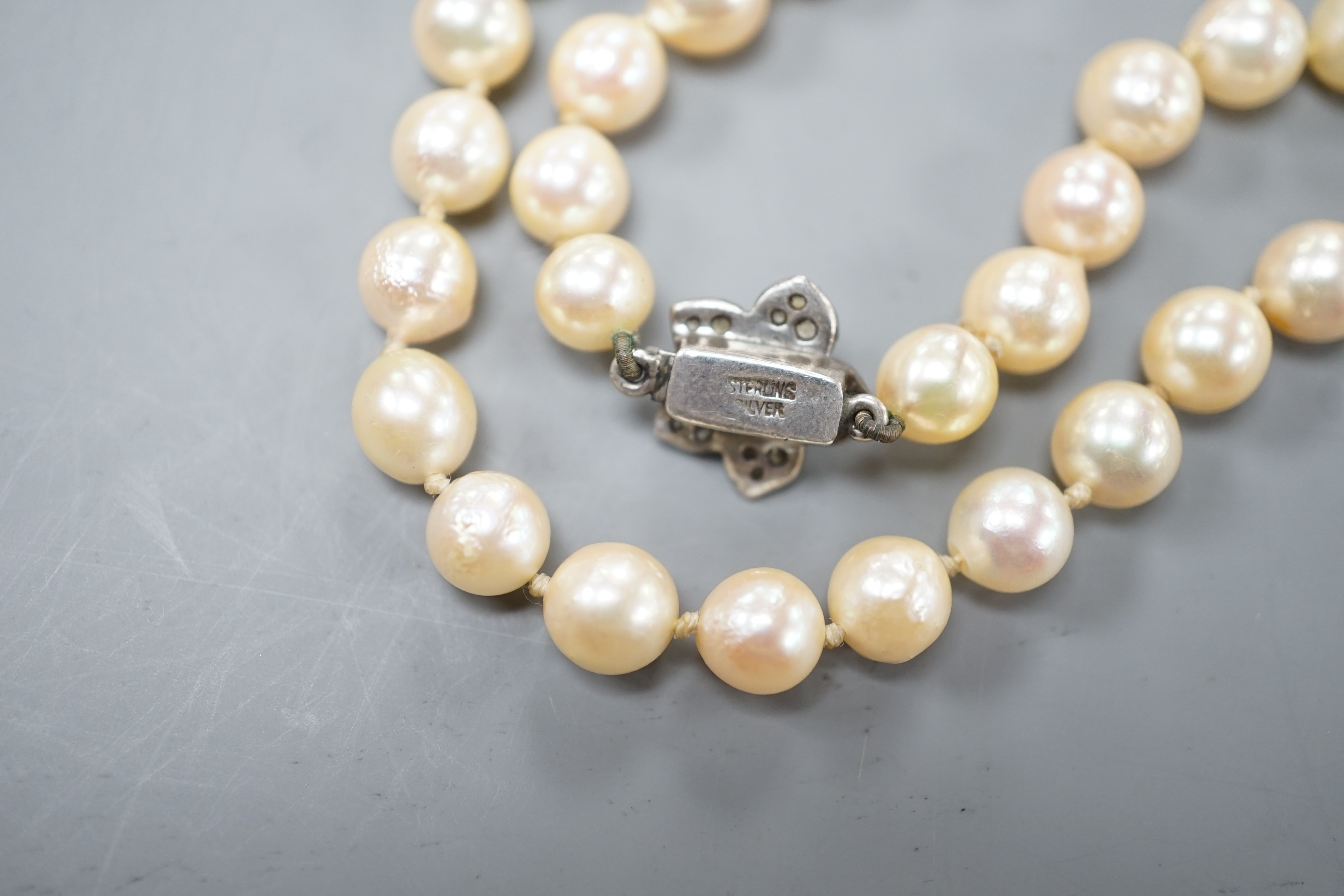 A single strand culture pearl necklace with cultured pearl set sterling clasp, 74cm.